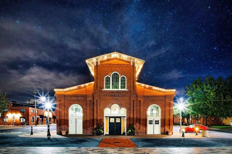 Broad Street Market's historic Stone Building illuminated at night in Harrisburg