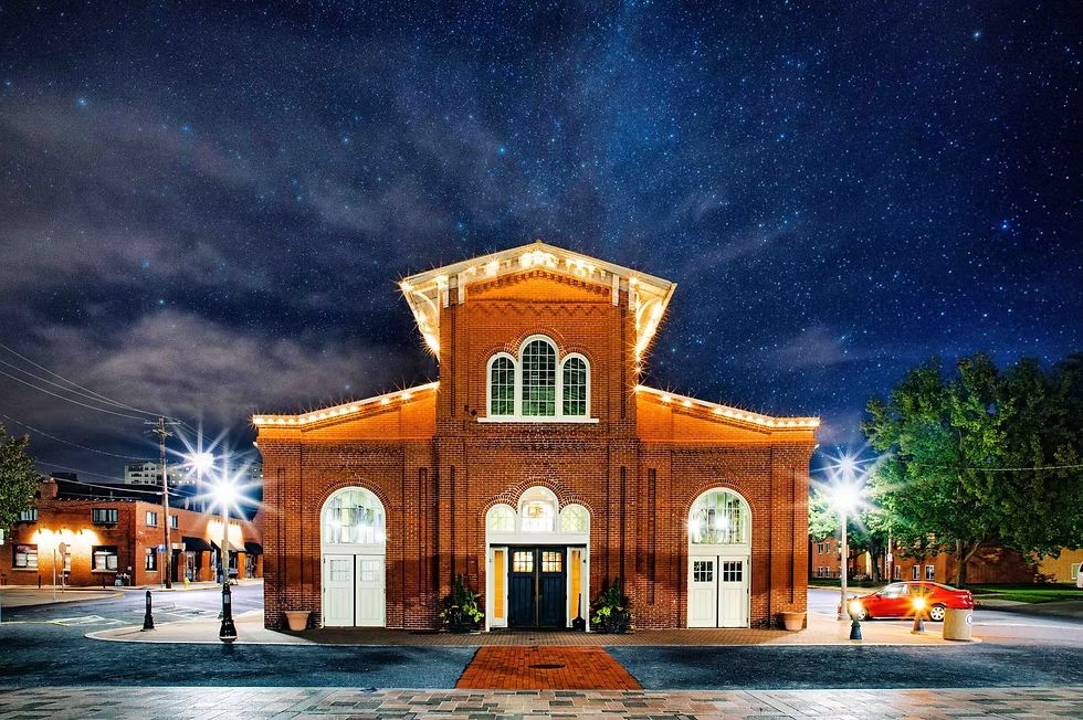 Broad Street Market's historic Stone Building illuminated at night in Harrisburg