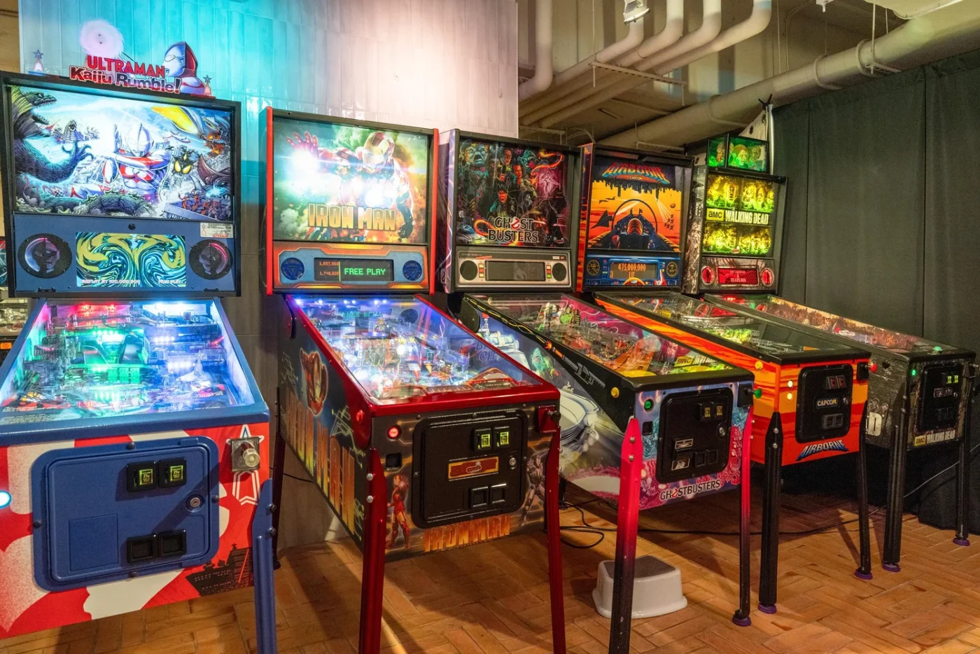 Row of pinball machines at The Pinball Basement below UPSIDE on Moore