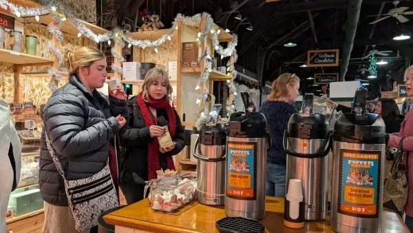 Holiday shoppers sampling coffee at a vendor counter inside the 2nd Street Market in Dayton