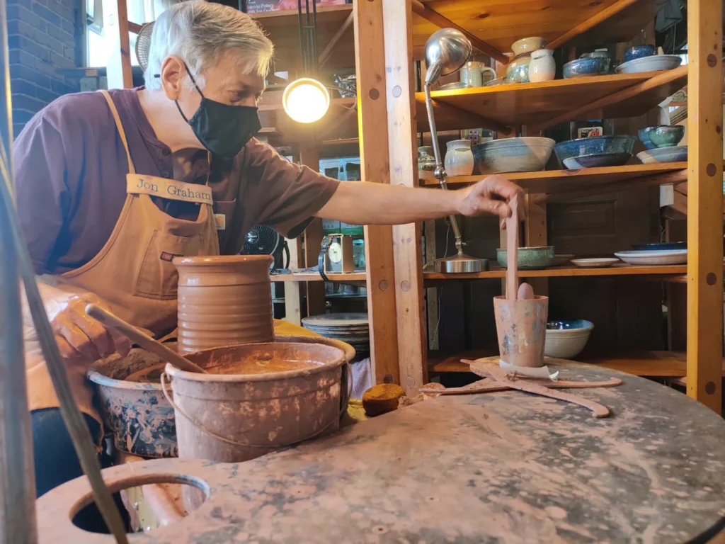 A potter shaping clay at a pottery stall inside the 2nd Street Market in Dayton