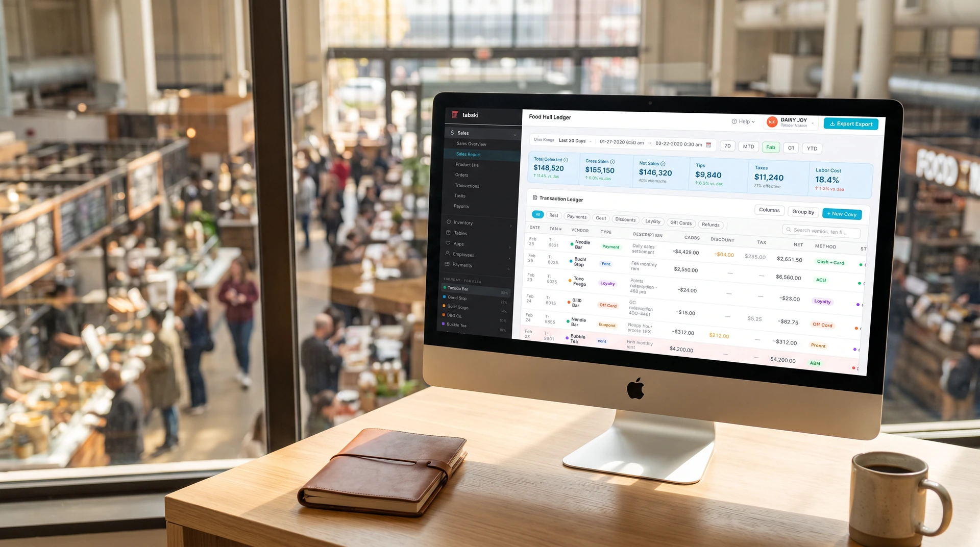 Tabski Food Hall Ledger showing item-level transactions across vendors on an iMac overlooking a busy food hall